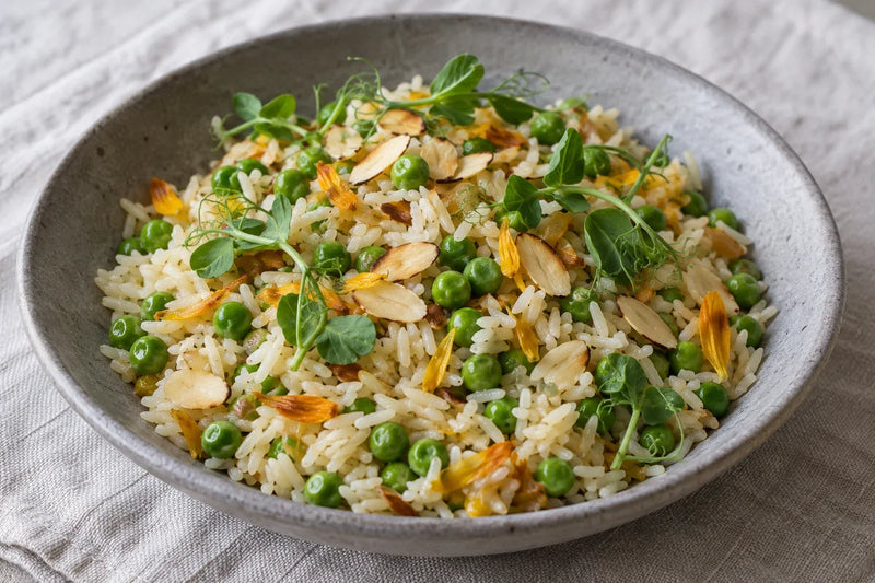AI-generated serving illustration: Calendula Petal Rice with Peas with speckled pea shoots