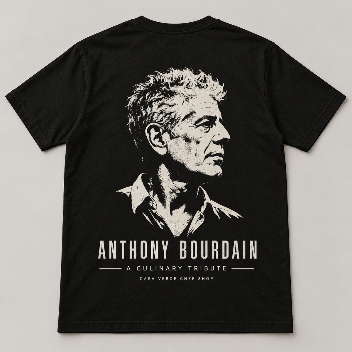 Anthony Bourdain culinary tribute — approved back design preview with a cream portrait, name and Casa Verde Chef Shop signature on a dark shirt.