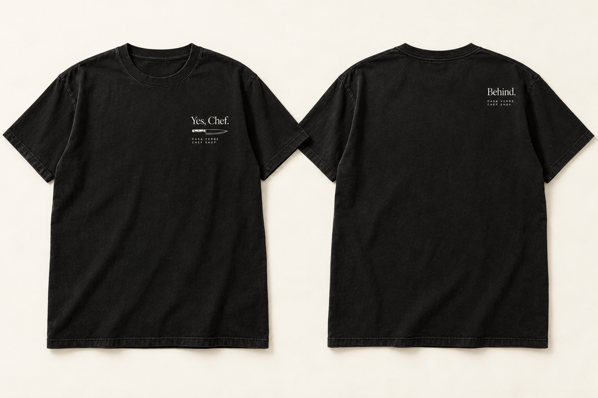Yes, Chef. / Behind. — approved front-and-back design preview: small cream lettering and knife on the front, with Behind. on the back. Concept pair, not a production proof.