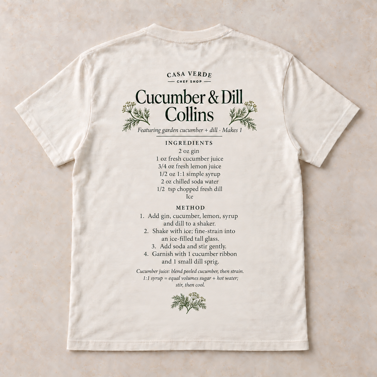 Cucumber & Dill Collins T-Shirt — approved individual back design preview with cocktail-recipe lettering and matching botanical illustration and the Casa Verde Chef Shop signature. Illustrative garment mockup, not a production master.