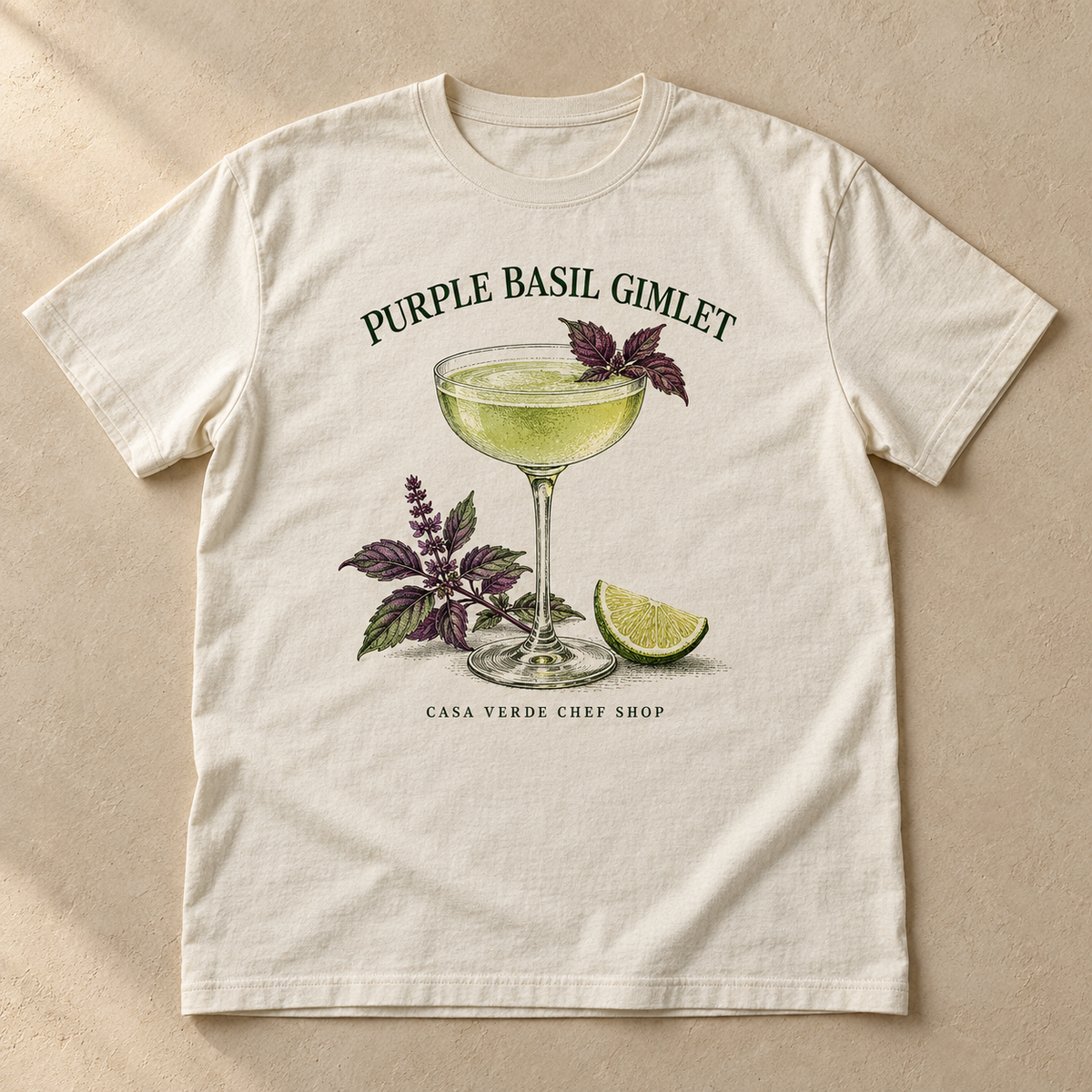 Purple Basil Gimlet T-Shirt — approved front preview with an illustrated coupe, pale green cocktail, purple basil, lime, title and Casa Verde Chef Shop signature.