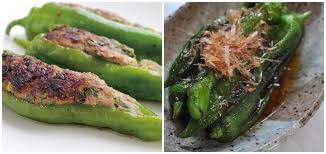 Stuffed green Manganji  peppers with a side of sauce on a white plate