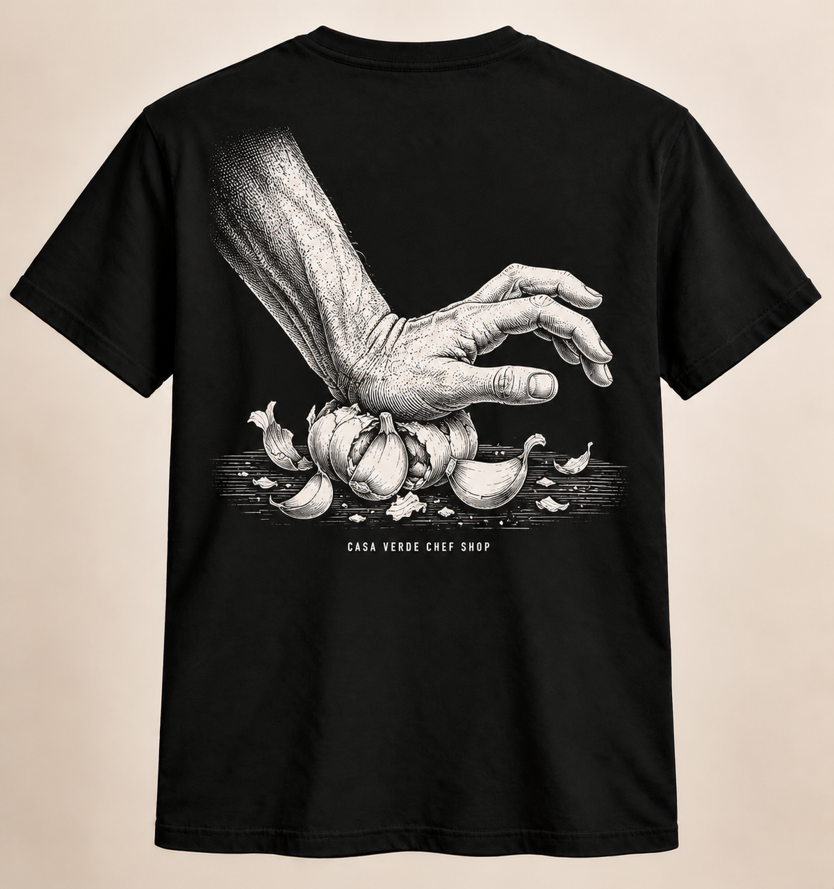 More Garlic. T-Shirt back design preview with a white etched culinary hand illustration and Casa Verde Chef Shop signature.