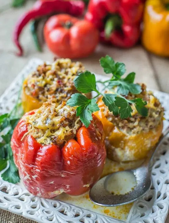 Stuffed portuguese goat heart peppers on a decorative plate with a spoon