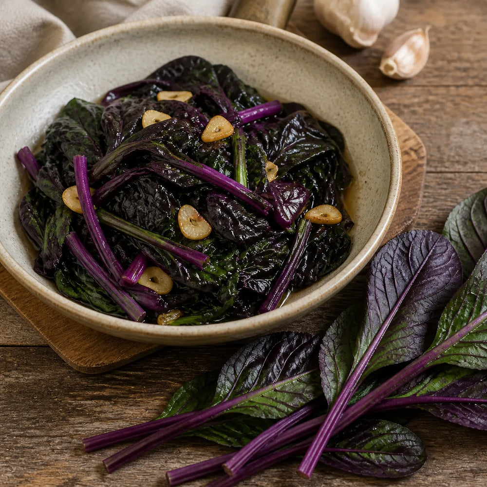 Lightly sautéed Purple Komatsuna Mustard with garlic beside fresh whole purple leaves
