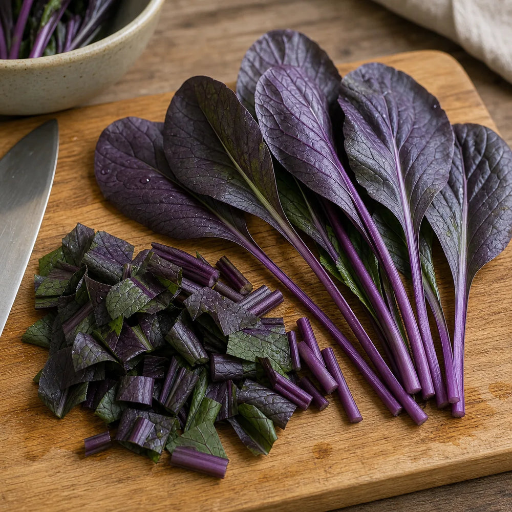 Purple Komatsuna Mustard leaves and violet stems chopped on a wooden cutting board