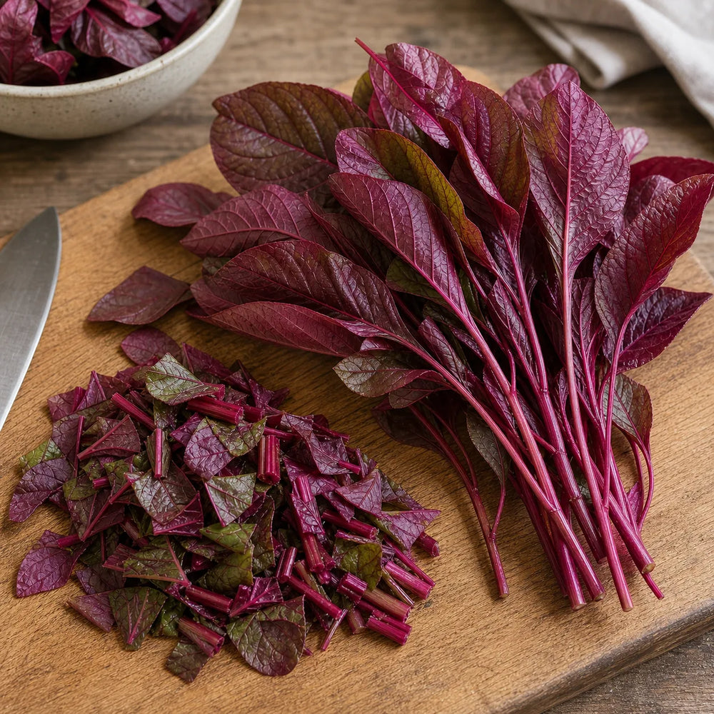 Red Amaranth leaves and tender stems chopped on a wooden cutting board